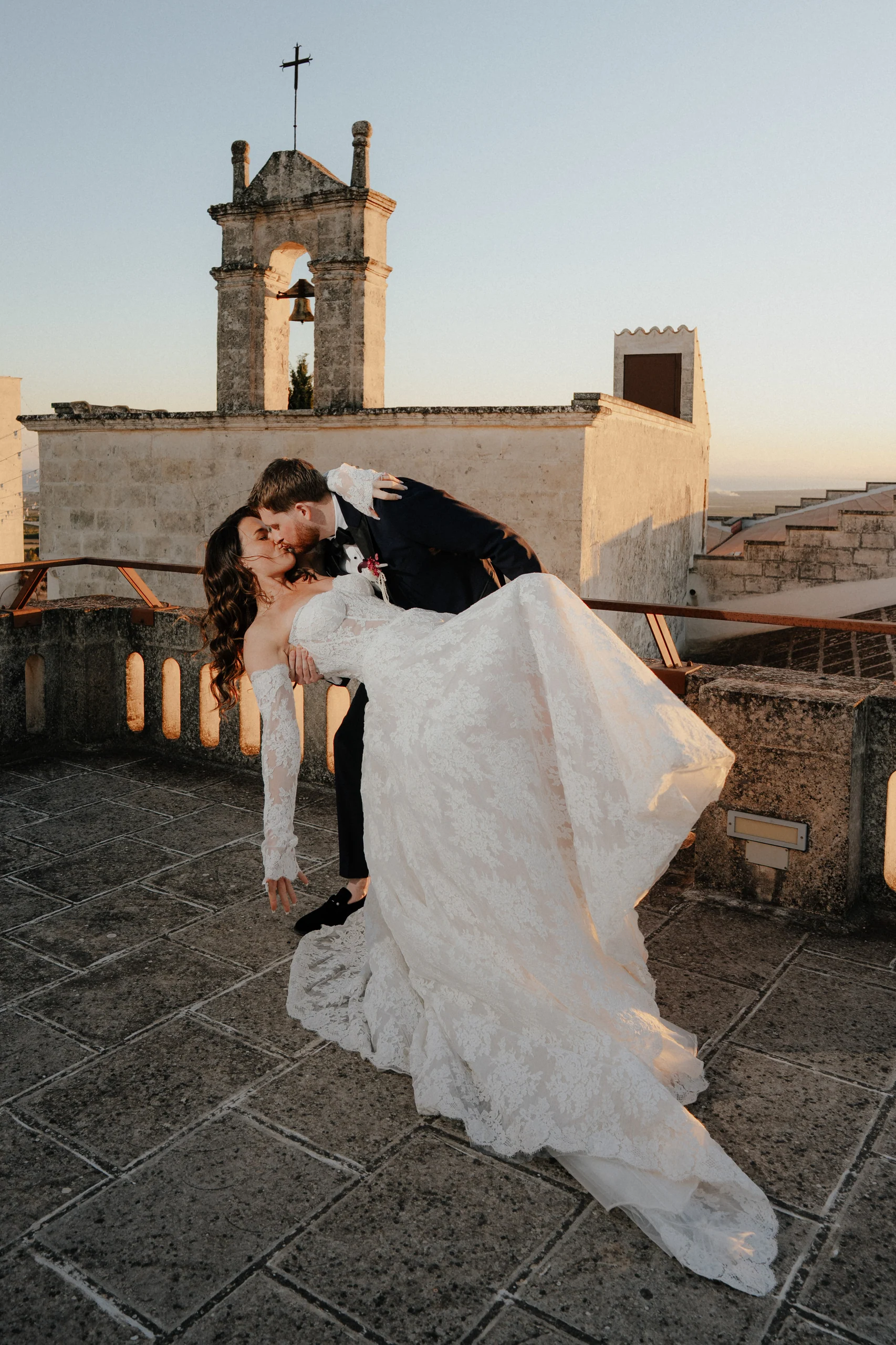 Brooke and Calvin on the terrace at Masseria Amastuola, in front of the bell tower