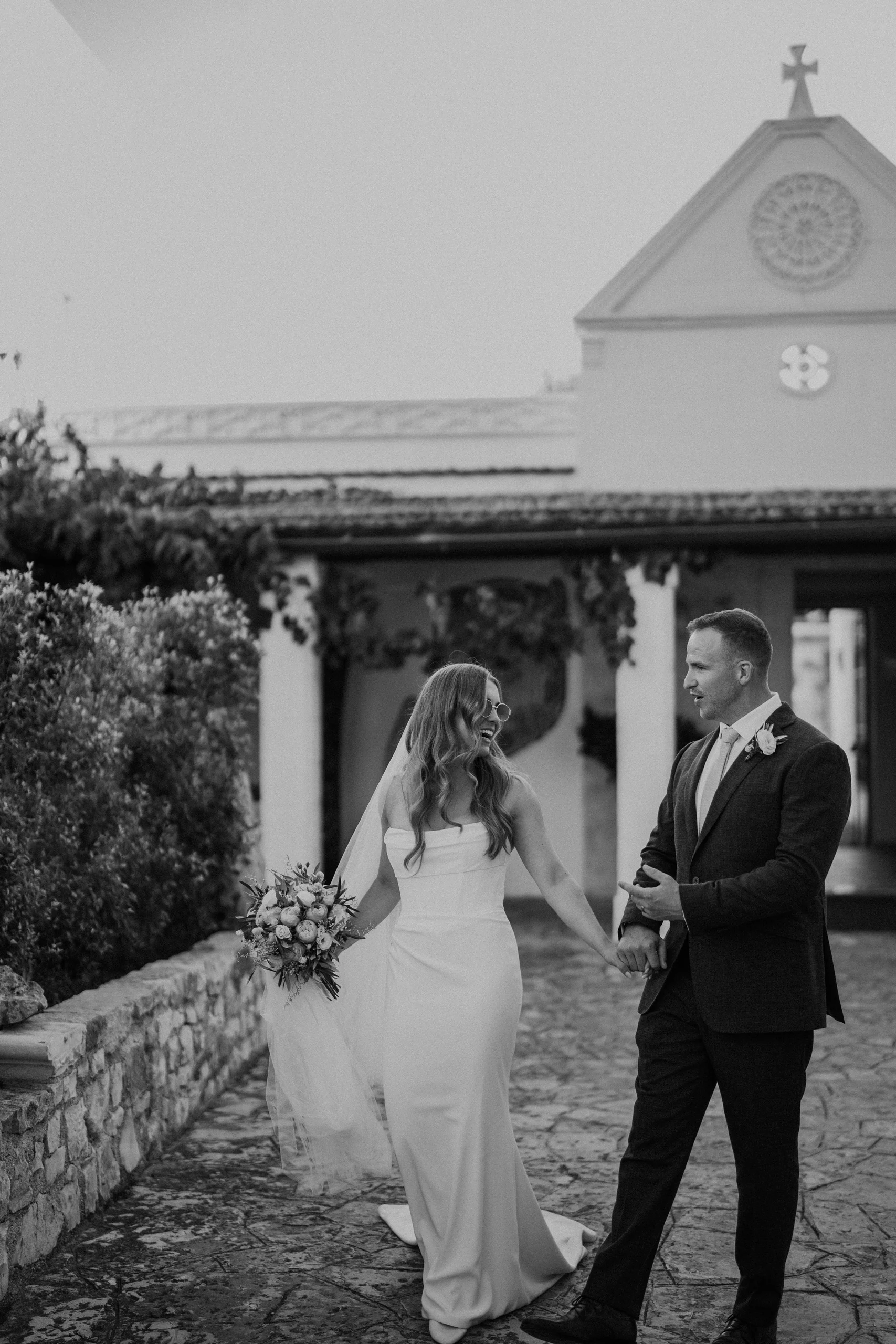 Black-and-white portrait of Sam and Beth in front of the masseria